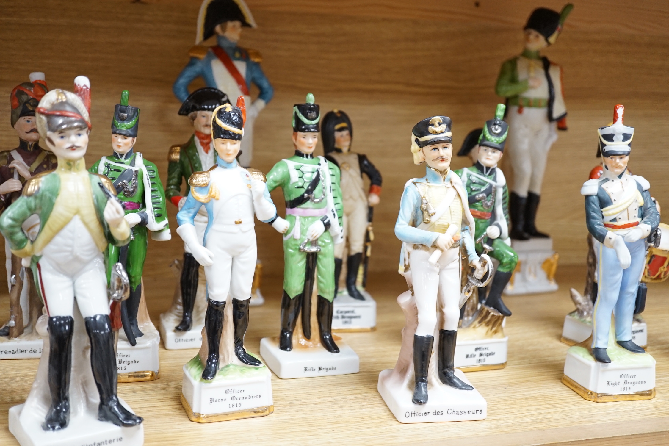 Twenty porcelain figures of soldiers including Officer Light Dragoon and Rifle Brigade, largest 31cm high